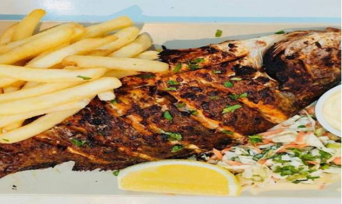 Spicy whole grilled Barramundi fish meal
